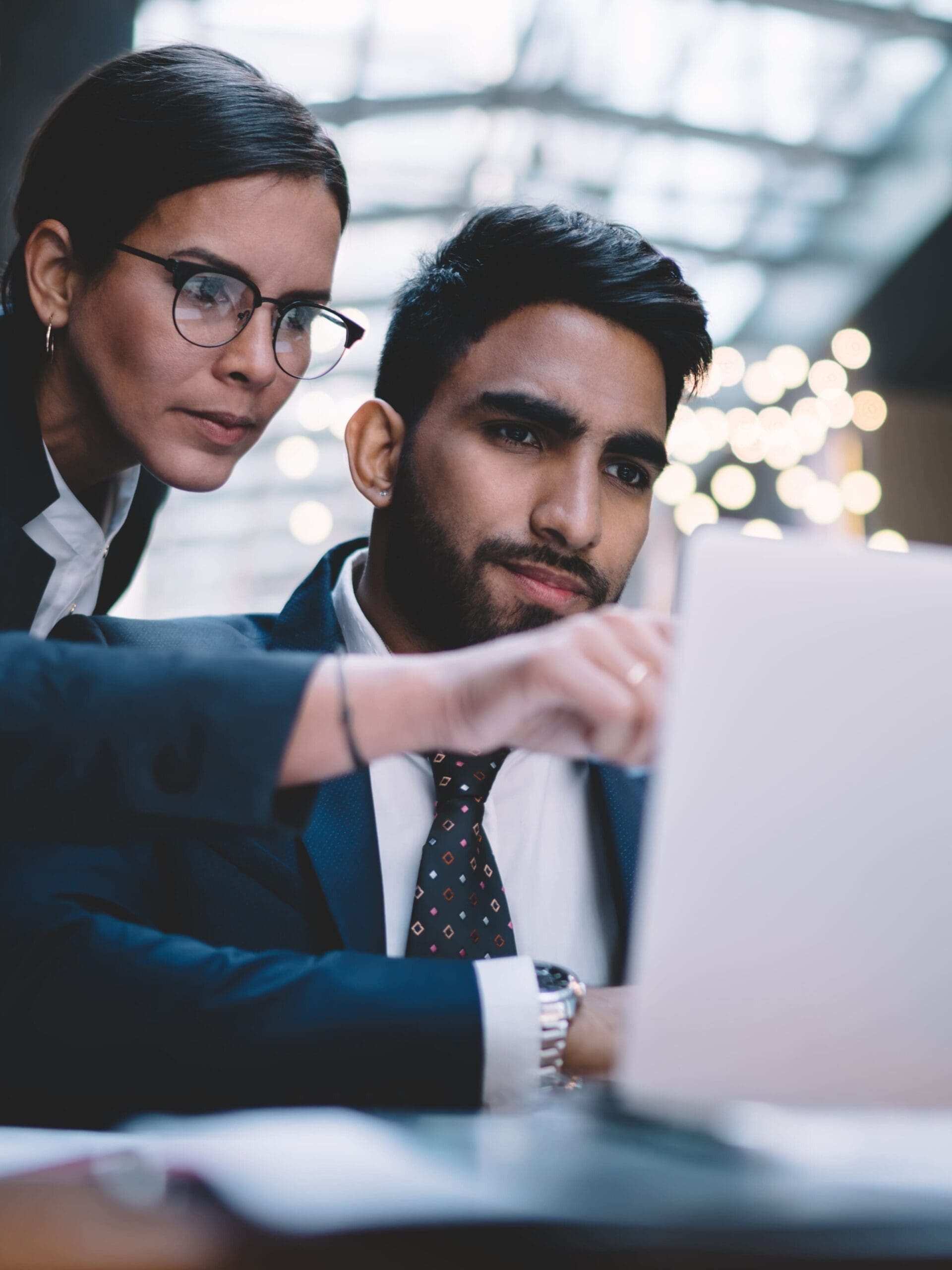 Woman pointing on screen working with colleague