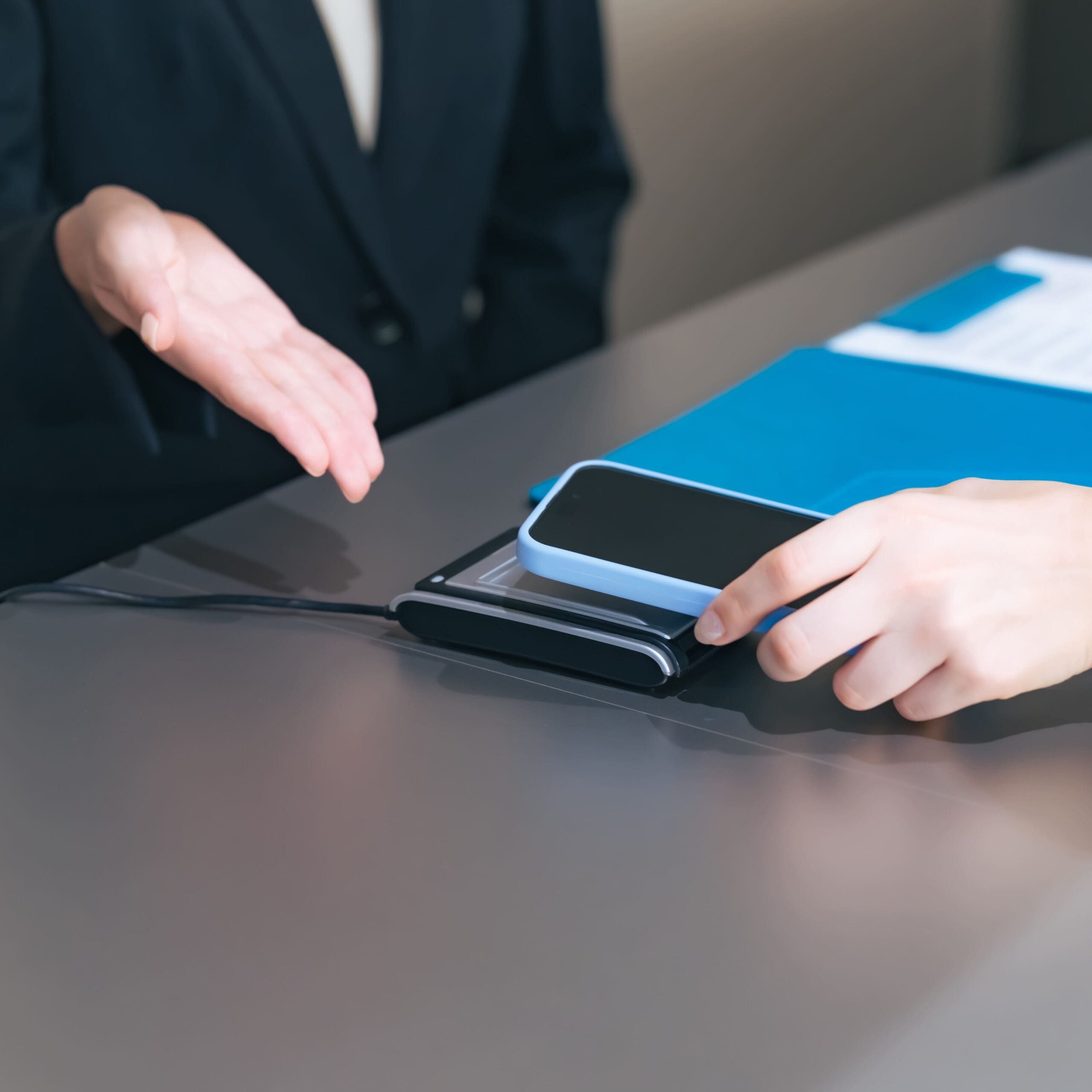a woman's hand paying by smartphone