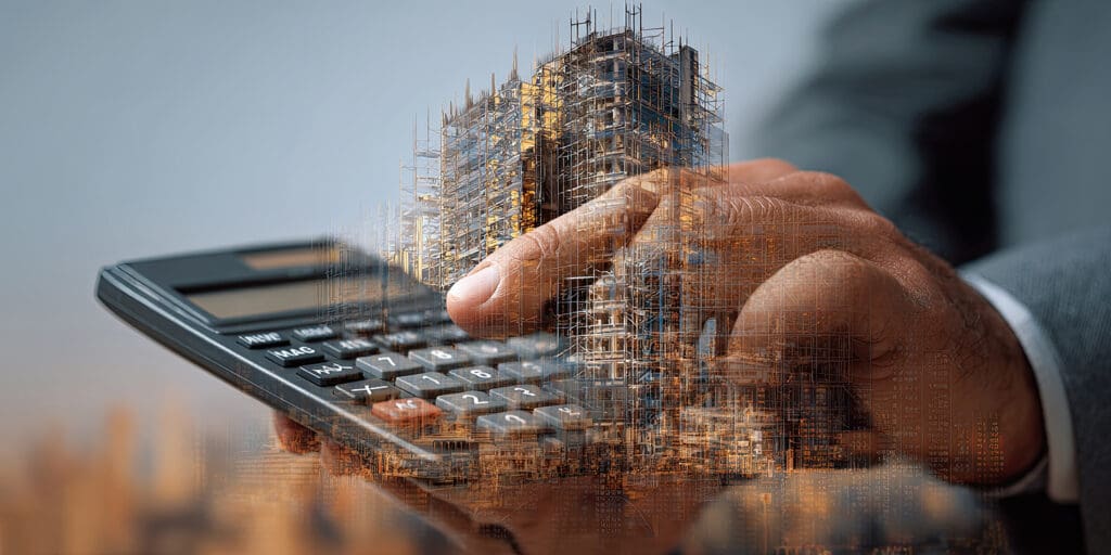 A person with a calculator and an overlay of a building under construction.