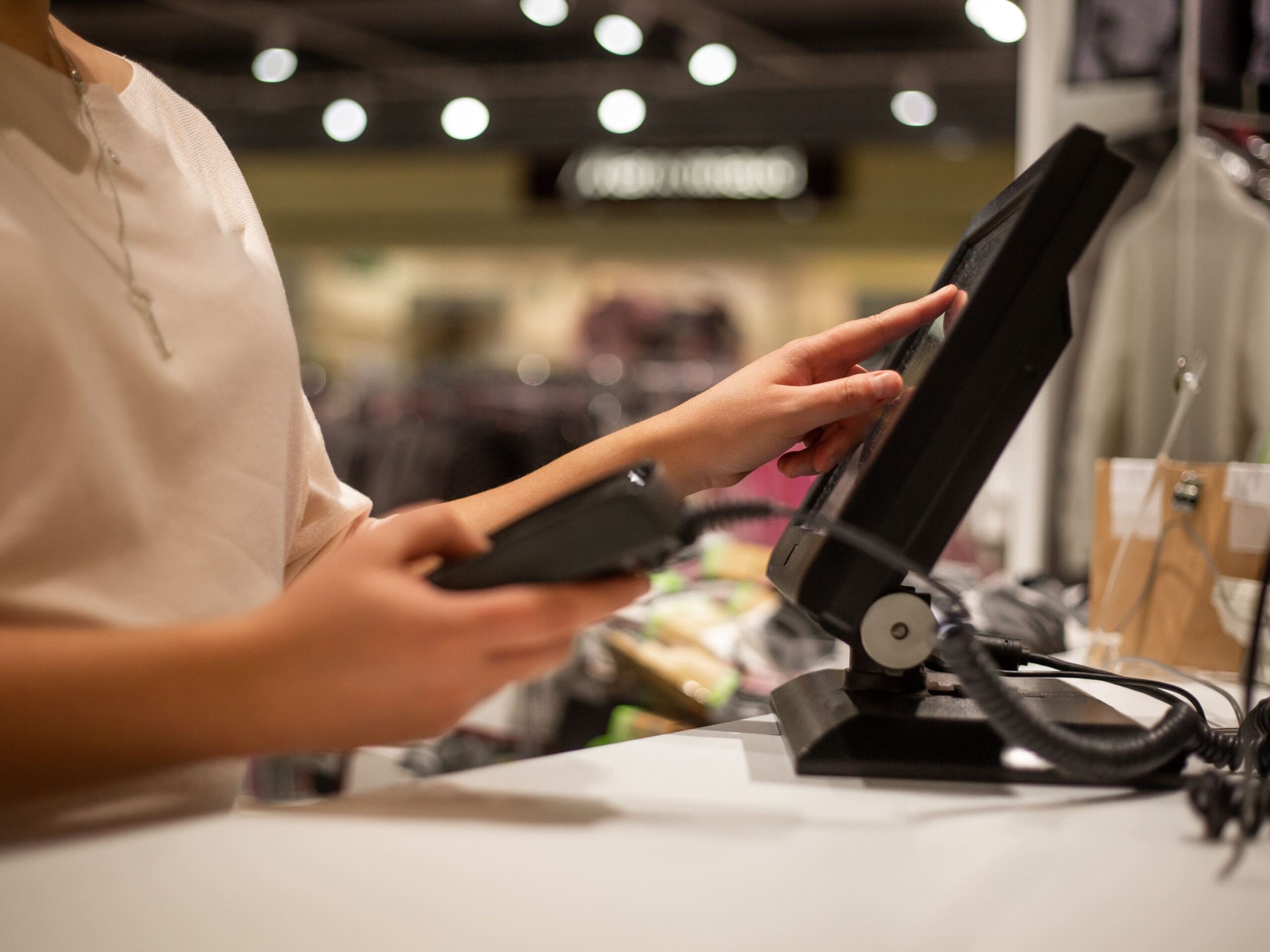 woman scanning sale information on touchscreen register.